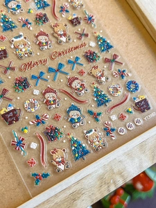 Detail of 3D embossed Christmas nail stickers featuring bears and holiday trees