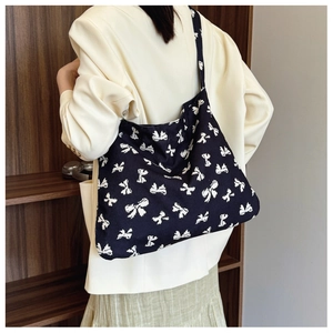 Close-up of leopard pattern canvas tote bag with white butterfly print details