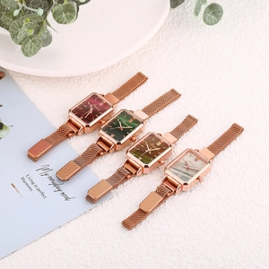 Detail view of four rectangular quartz watches with Milanese rose gold mesh bands