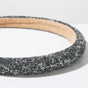 Close-up of sparkling grey glitter headband showing soft beige anti-slip fabric lining