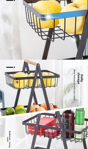 Detail of 2-tier black metal fruit basket with wooden handle for kitchen storage