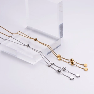 Minimalist double layer bead necklace in gold and silver finish with adjustable pull chain