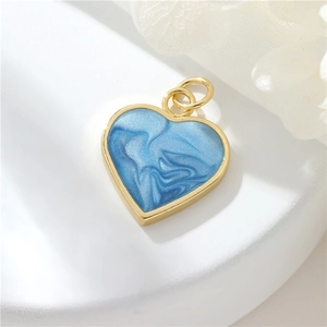 Detailed view of blue marble heart charm with gold plating for DIY jewelry making