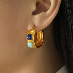 Chunky gold C-shape hoop earrings with blue natural stones in a vintage style