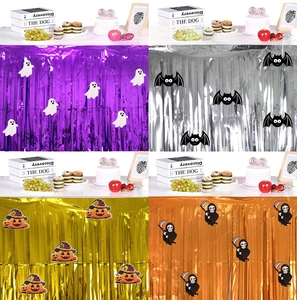 Halloween foil fringe table skirts in purple and orange with spooky DIY sticker decals