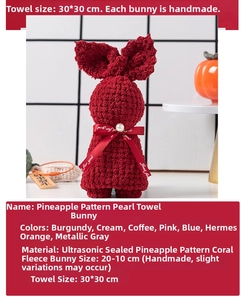 Detail of burgundy coral fleece towel bear with pearl and red ribbon gift packaging