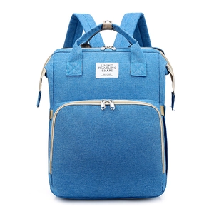 Close-up of light blue baby diaper bag showing durable fabric and front zipper pocket