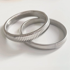 Minimalist silver wide stretch bangle bracelets with textured industrial metal finish