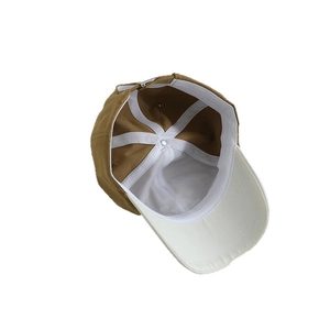 Inside view of khaki kids baseball cap with white lining and metal adjustable buckle