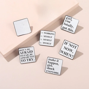 Minimalist square metal enamel pins with inspirational English quotes on pink surface
