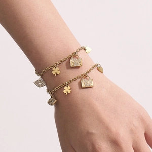 Professional photo of 18K gold plated stainless steel charm bracelet on woman wrist