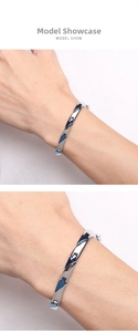Detail show of men's stainless steel bracelet with blue triangle magnetic elements