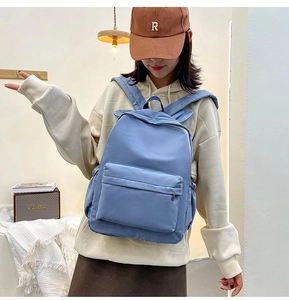 Blue backpack with rabbit ears shown from a side-back view on a model for daily use