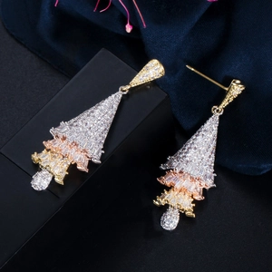 Macro shot of luxury Christmas tree earrings with micro-set zircon in three-tone finish