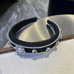 Detailed close-up of handmade black headband with luxury rhinestones and pearls