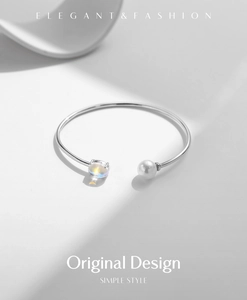 Detailed close-up of a silver S925 sterling silver open bracelet with pearl and gemstone