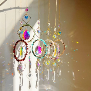 Close-up of crystal suncatchers with natural stones casting rainbow light on wall