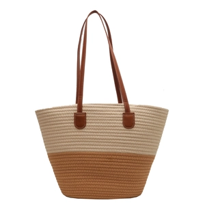 Handwoven beige and brown cotton shoulder tote bag with leather handles in minimalist style