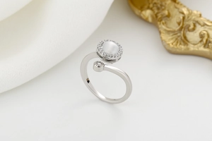 Detail of adjustable spinning ring with cat eye stone and pavé zircon setting