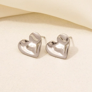 Close-up of heart-shaped 304 stainless steel earrings with textured hammered finish