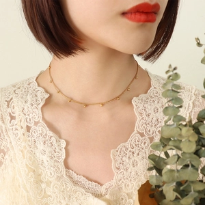 Minimalist gold beaded choker necklace for women with small beads on a fine chain