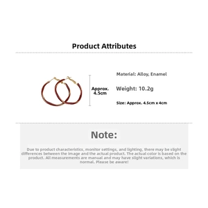Detail view of red enamel twisted hoop earrings with 10.2g weight and 4.5cm diameter