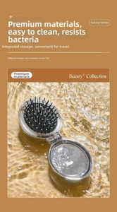 Close-up of a foldable hairbrush with integrated mirror and silver metallic finish