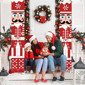 Family sitting by festive door decorated with nutcracker soldier Christmas banners