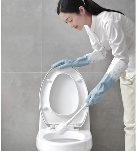Close-up of blue waterproof cleaning gloves with floral cuffs and a toilet brush detail