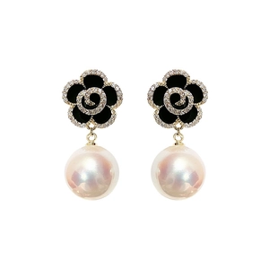 Elegant black rose petal earrings with pearls and gold finish on a white background