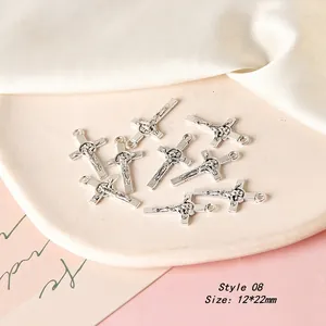 Detail view of vintage silver alloy crucifix charm with 12x22mm size for DIY earrings