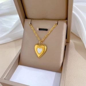 Golden titanium steel heart pendant necklace on rope chain inside a beige gift box