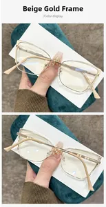 Detail view of cream gold metal glasses frame with vintage aesthetic and slim temples