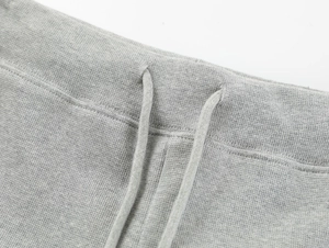 Close-up of high-waist yoga shorts showing drawstring details and knit fabric texture