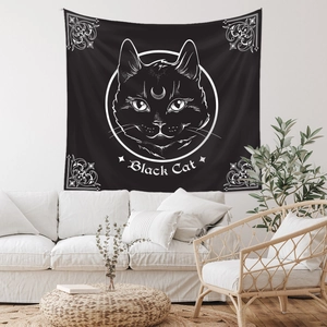 Detailed view of a black cat wall tapestry with white line art in a cozy living room setup