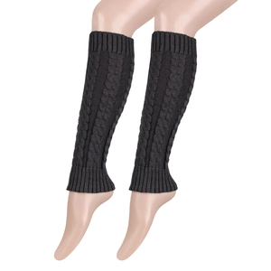 Detail view of dark grey cable knit leg warmers with thick ribbed cuffs and pattern
