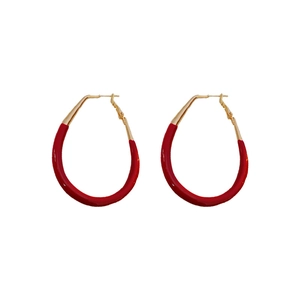 Modern red enamel drop earrings with gold-plated sterling silver needle on white base