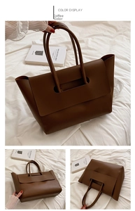 Detail view of large dark coffee tote bag with matte texture and geometric flap cover