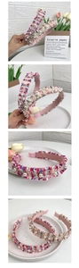 Detail view of woven fabric headbands with elegant imitation pearls in soft pink tones