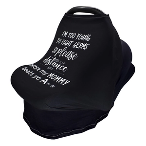 Detail of baby car seat cover featuring white slogan print I am too young to fight germs