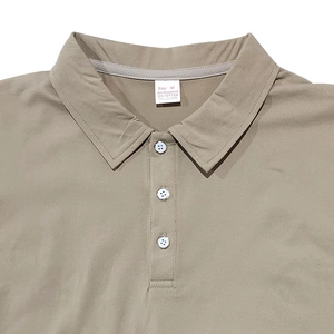 Detail shot of khaki polo collar with buttons and internal care label showing M size