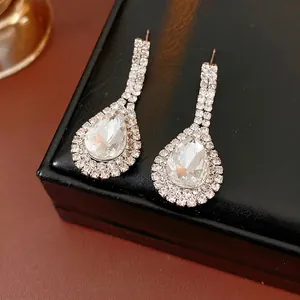 Elegant silver teardrop earrings with crystals on a luxury black leather jewelry box