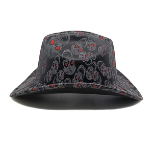 Close-up of black denim cowboy hat with skull pattern and red glitter eye details