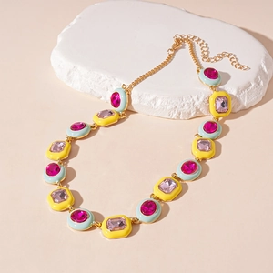 Detail of colorful enamel geometric pendant necklace with sparkling crystals in gold