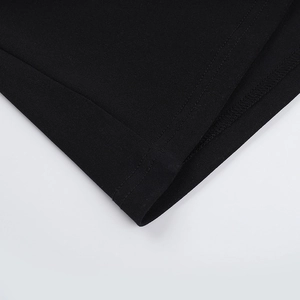 Close-up of high-quality double-needle stitching on black knit halter neck maxi dress