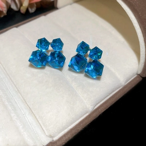 Detail of 18k gold plated silver earrings with green zircon and pearls in jewelry box