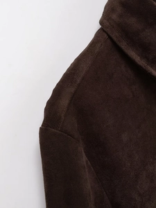 Close-up of shoulder seam and soft suede fabric texture on dark brown shirt jacket
