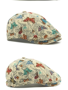 Close-up of vintage newsboy cap with colorful butterfly jacquard pattern and textures