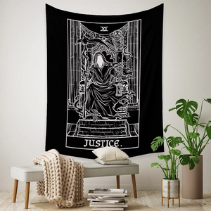 Gothic style black and white Justice Tarot card tapestry hanging on a white wall