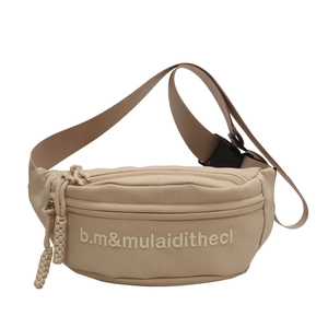 Beige canvas lettered chest bag with adjustable strap and braided zipper pulls